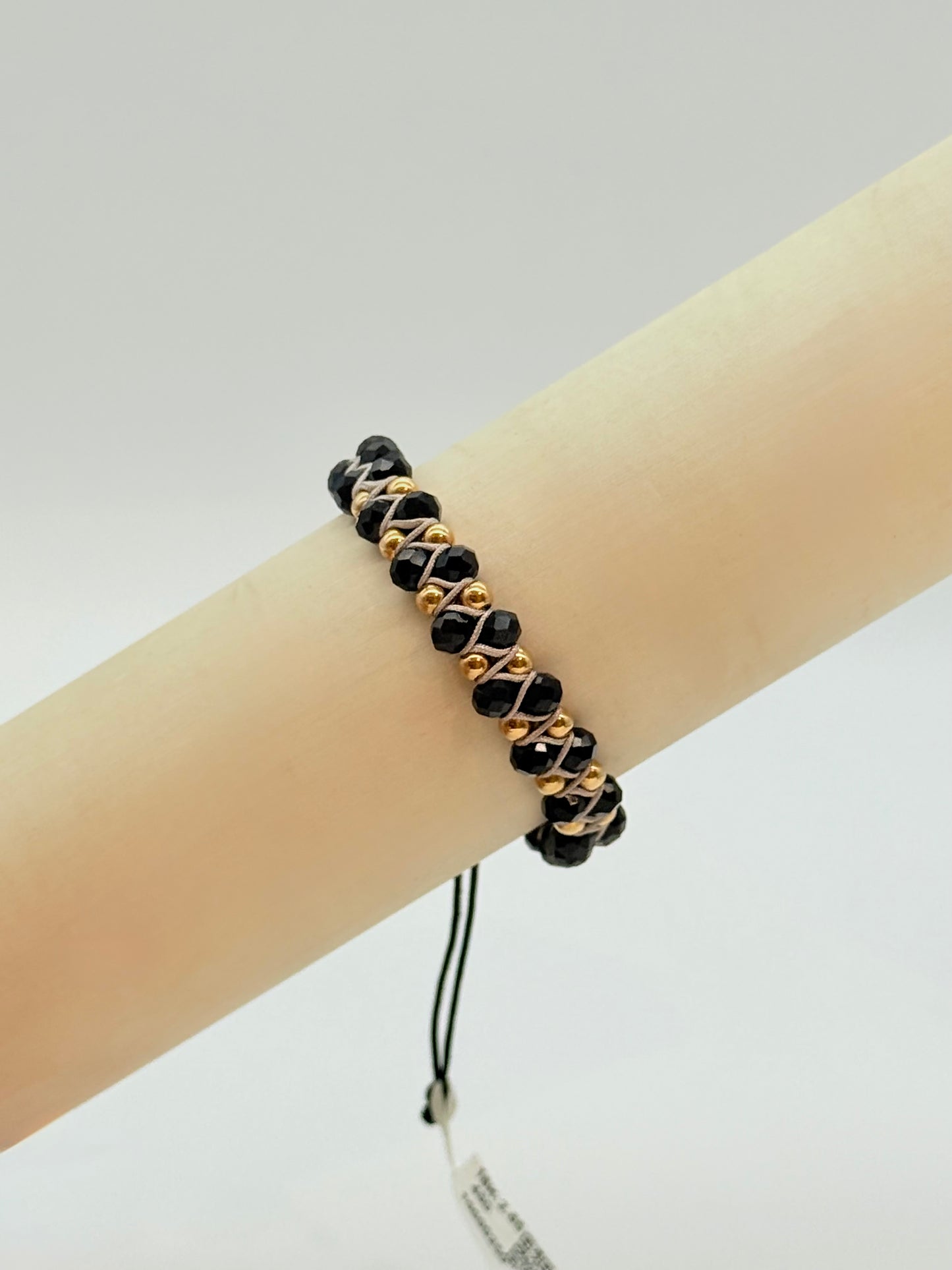 Glossy Black Faceted Beads With White Cord and Gold beads In Bracelet 18K