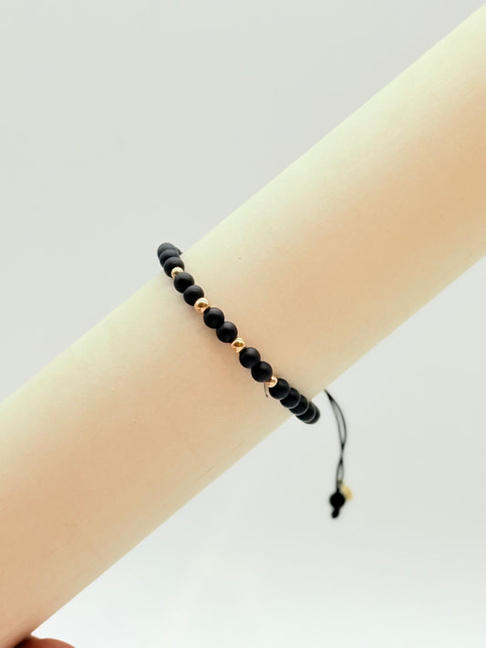 Black Matte Beads with 4 Gold Beads Bracelet In 18K